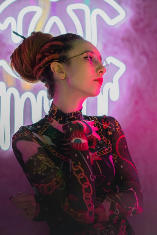 a woman standing in front of a neon sign