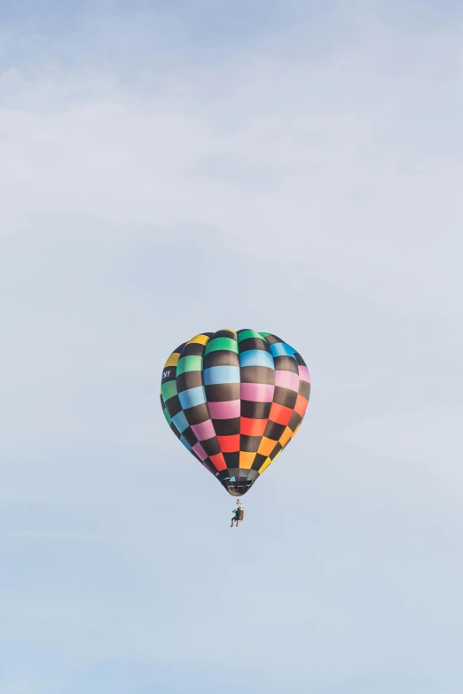 a colorful  air balloon that is flying through the sky