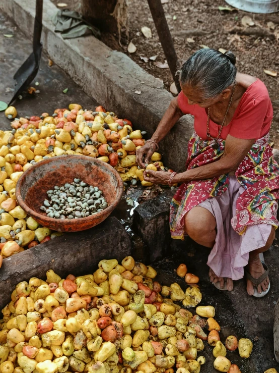 there is a woman kneeling down at the market