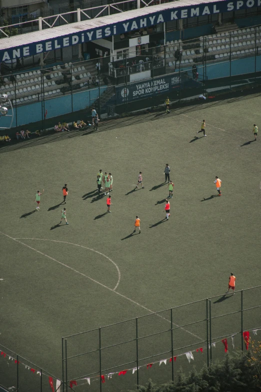 several soccer players are playing soccer on an empty field