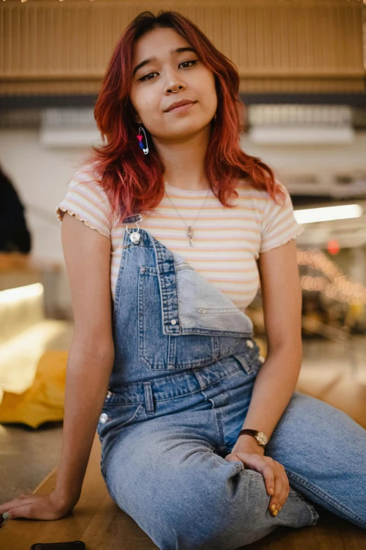 a woman with red hair sitting on the floor