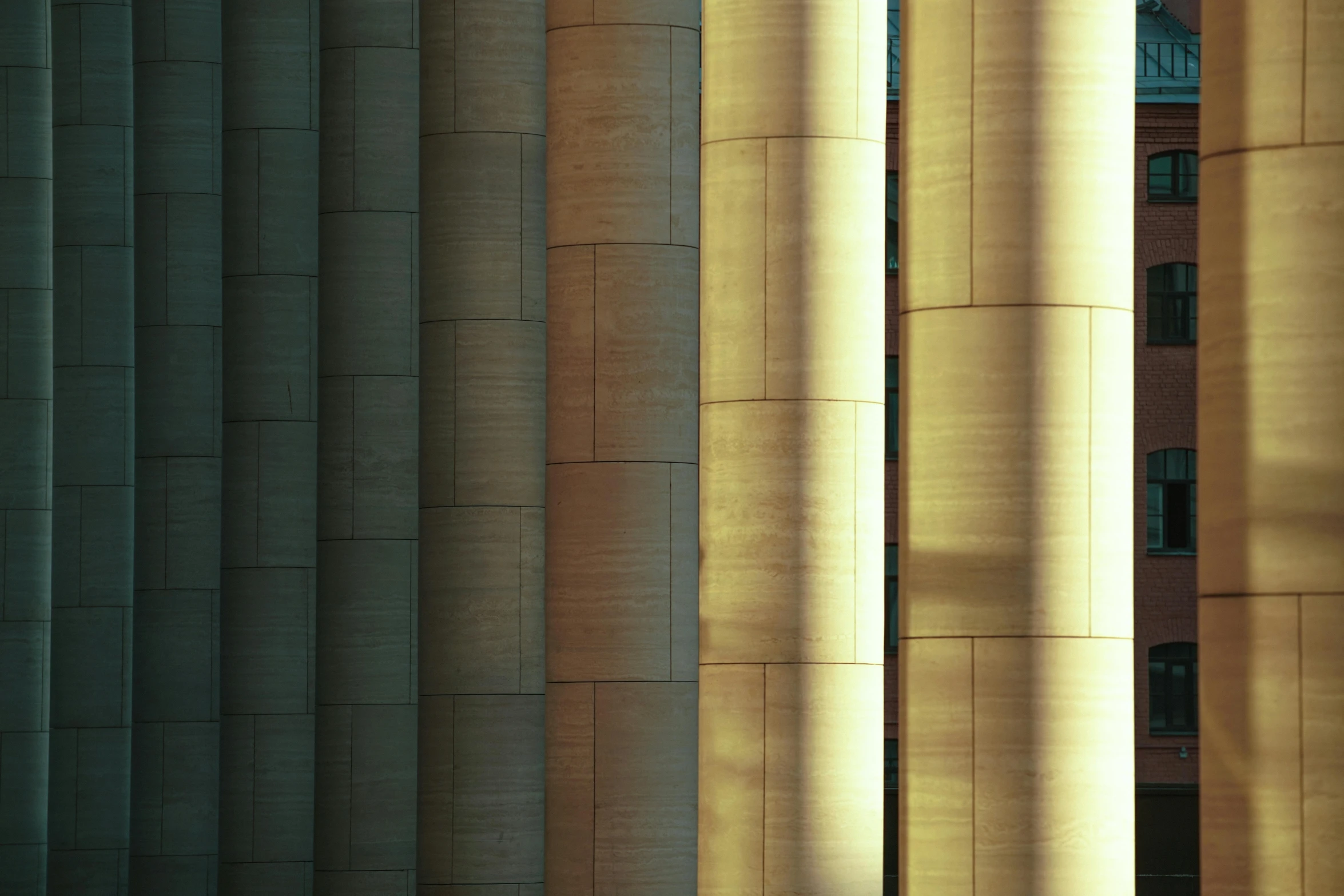 a couple of tall concrete columns in front of a building