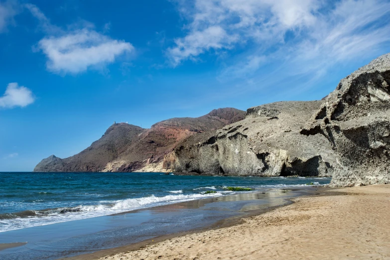 a beach area with water and rock formations