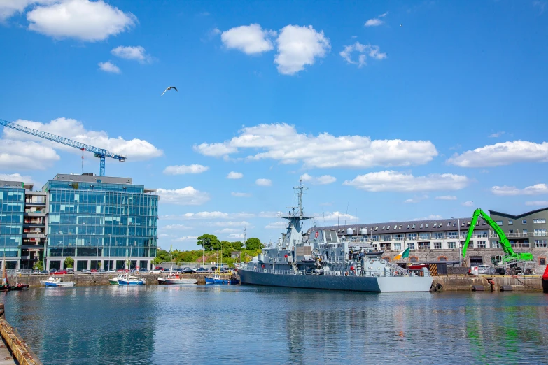 boats docked at the dock with cranes in the background