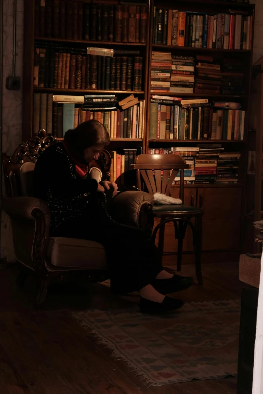 a person sits in a chair reading a book