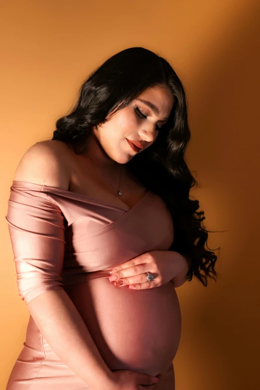 pregnant women with a big  and wearing an elegant pink dress