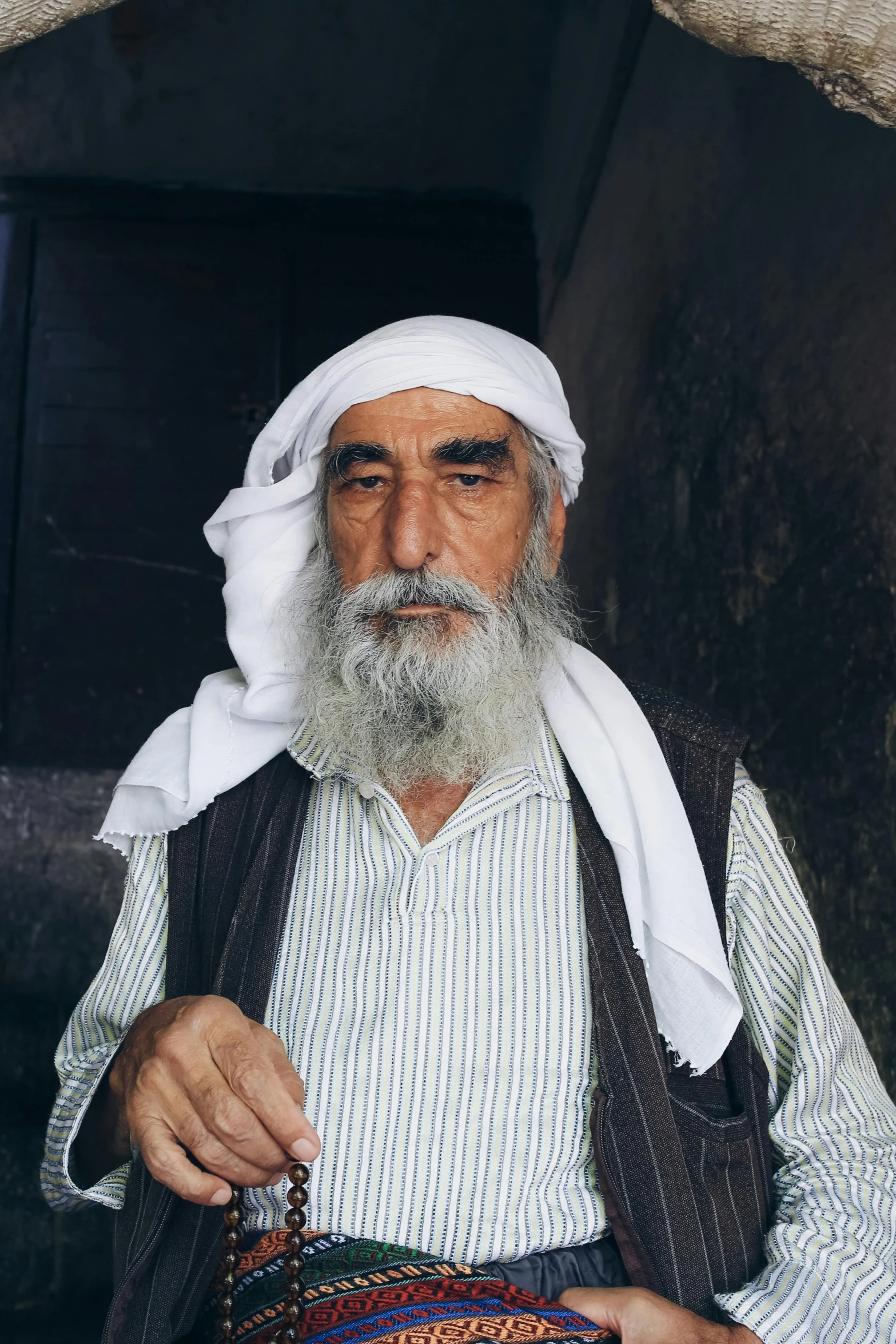 man with beard holding a bag on the street