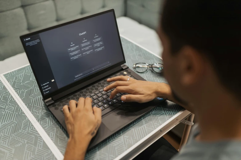 a man sitting at a table with a laptop