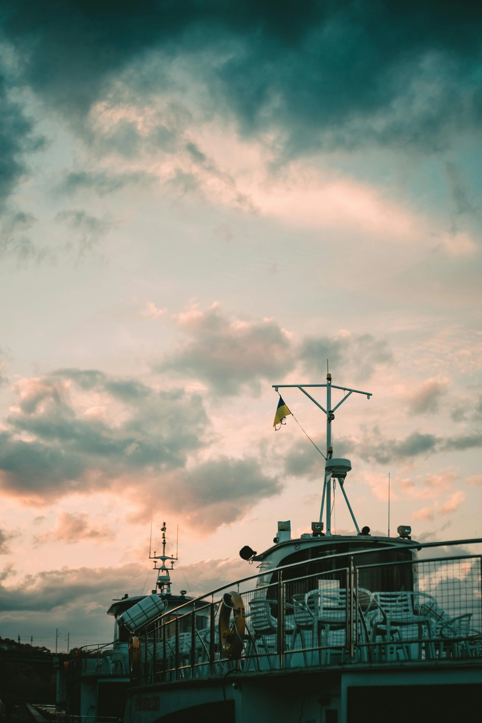 the view of a boat in the harbor during the sunset