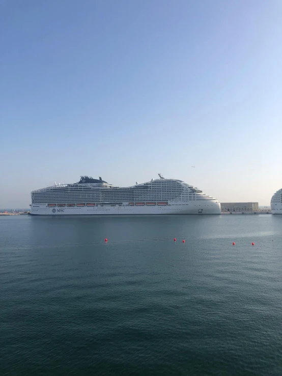 a cruise ship docked near other large boats