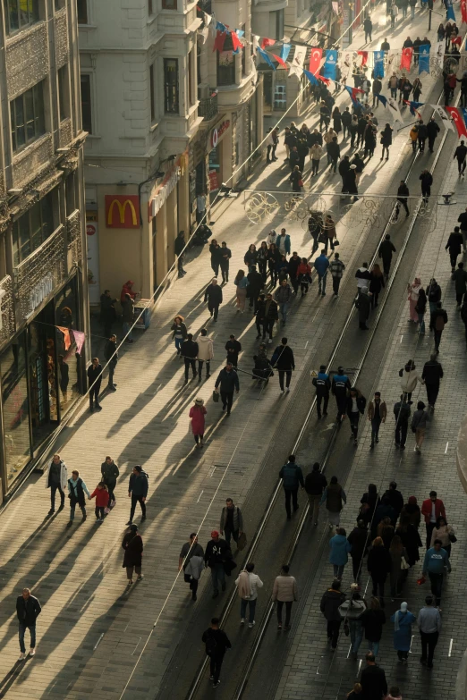 people walk down the street in a busy area