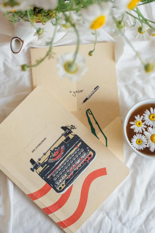 an old fashioned typewriter and some daisies