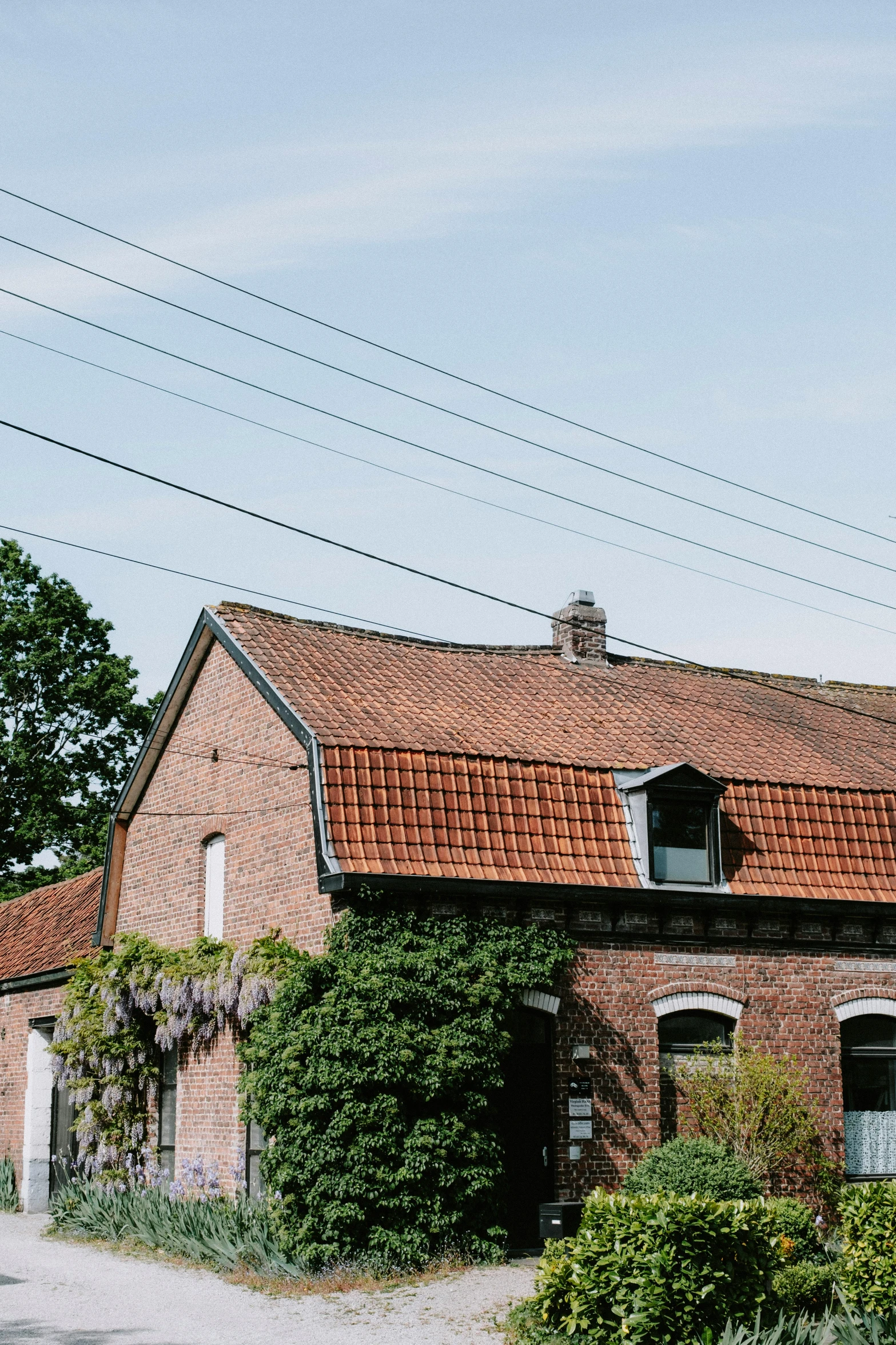 an old brick building with ivy growing on the front