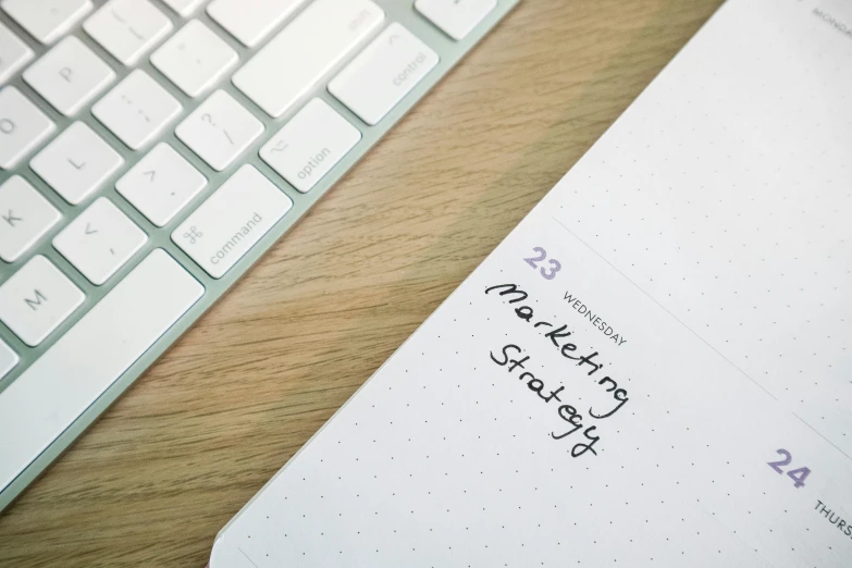 a close up of a notebook with a message next to a keyboard