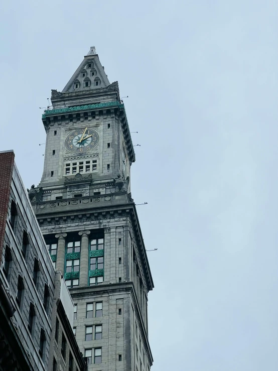 a tall tower with a clock that is standing in the sky