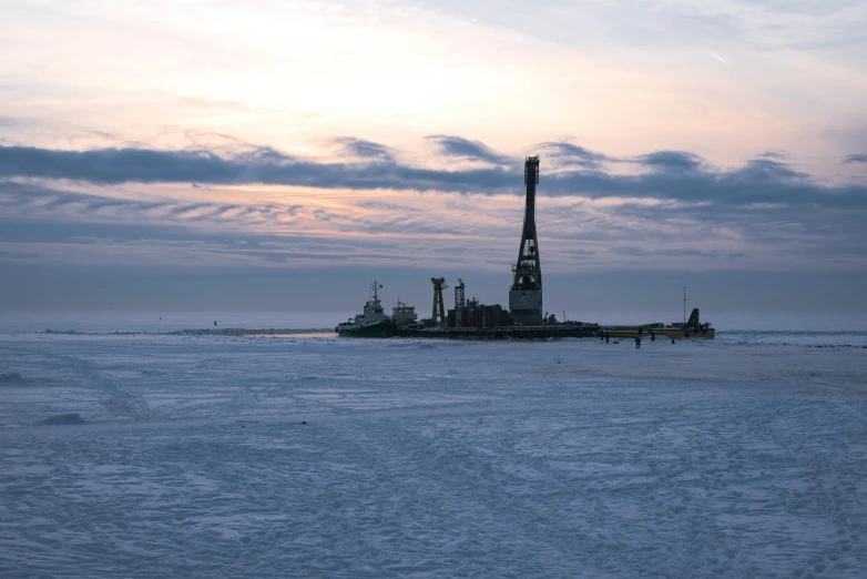 a group of cranes are anchored near an area covered in snow