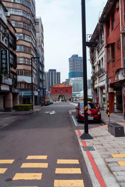 a city street with cars and buildings on the side