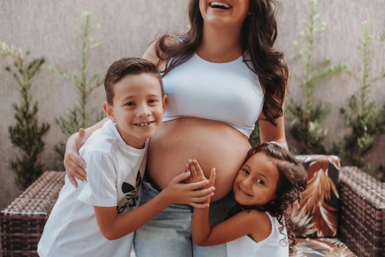 a young couple of people with their pregnant belly