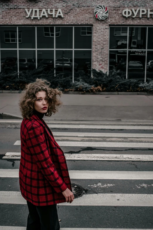 a woman on a street with a crosswalk