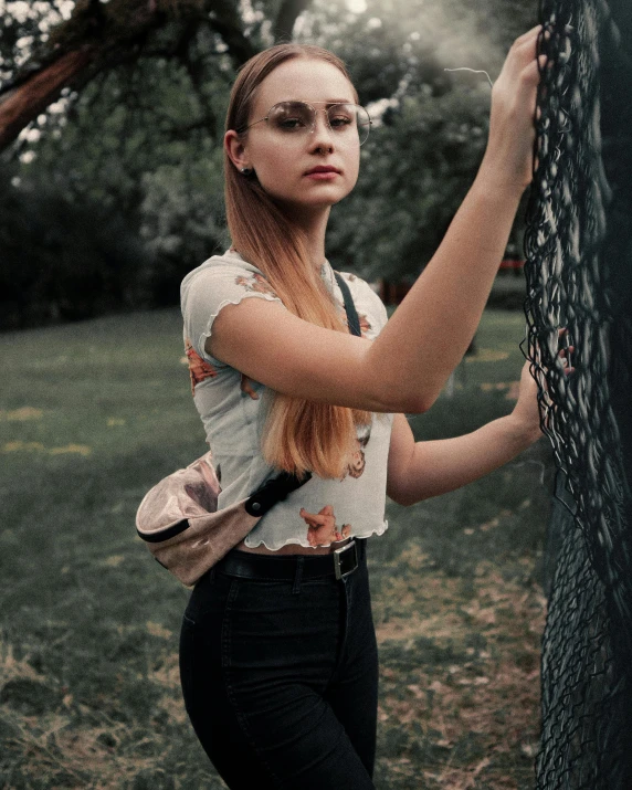 young lady holding on to the side of tree