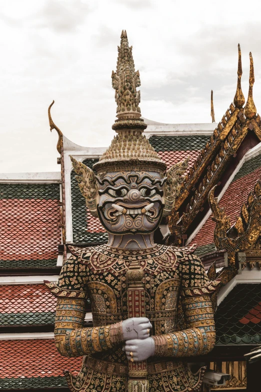 a large statue of a person made out of many colors