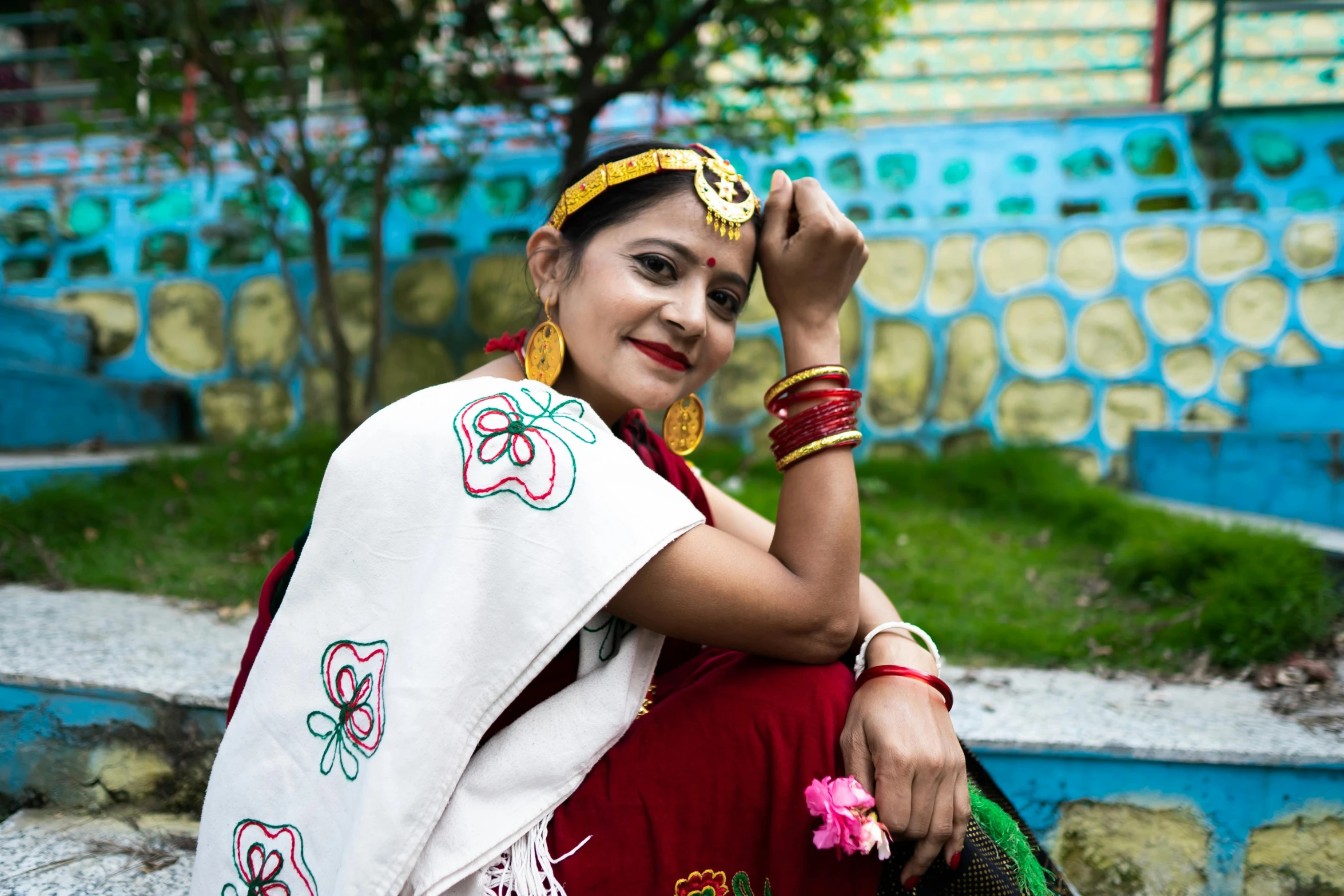 a woman with a saree sits on the street