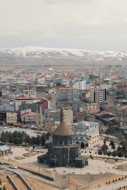 the top view of a small town with a clock tower in the foreground