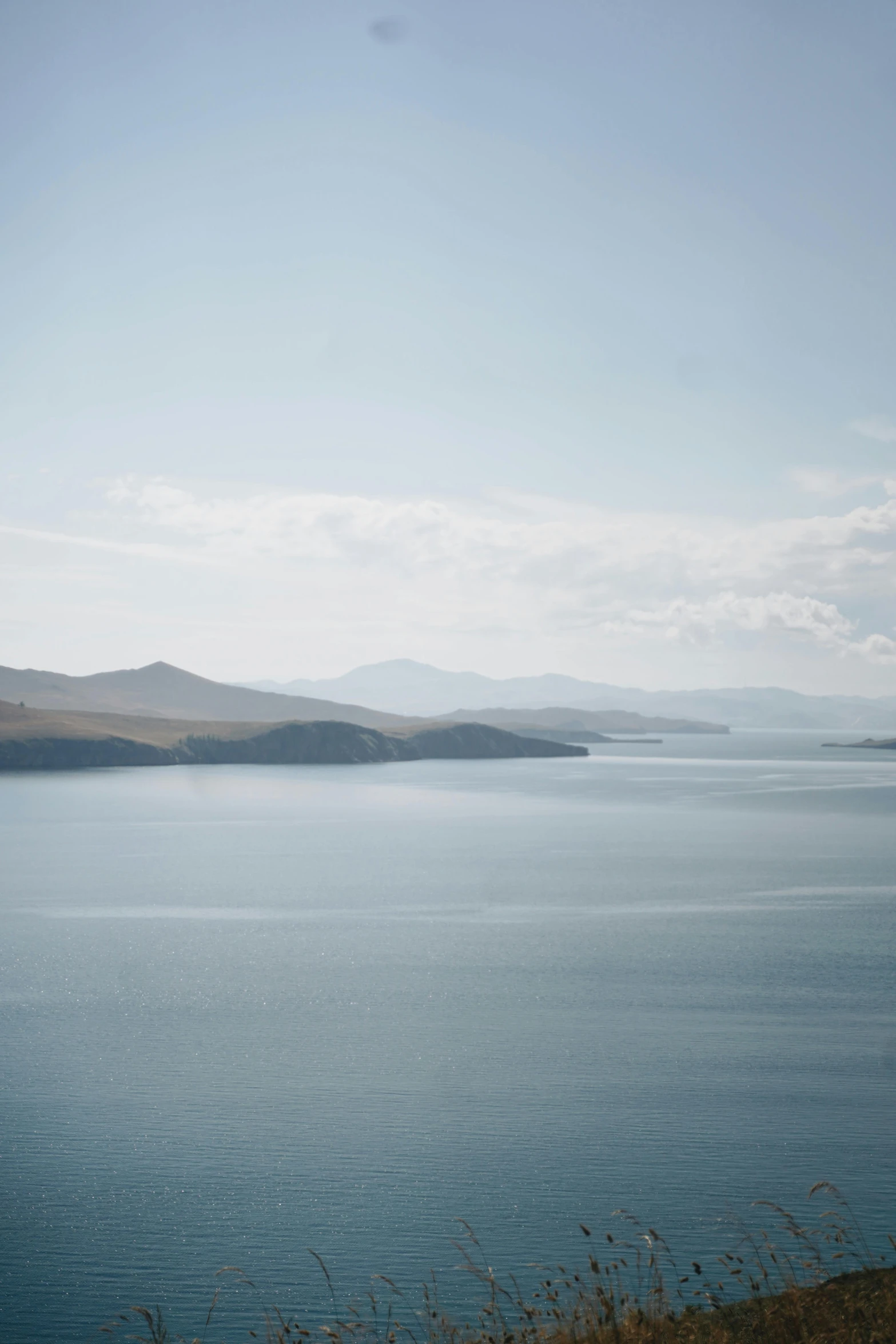 water view with mountain range in background and some cloud