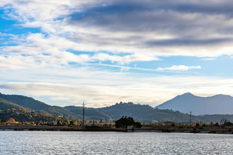 some water mountains and a boat in the distance