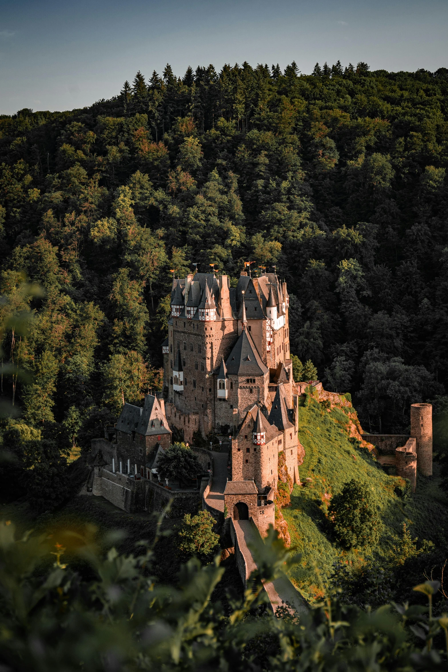 an old castle surrounded by trees and hills