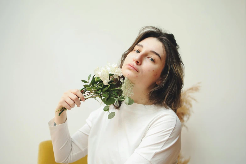 a  holding a bouquet of flowers and looking to her left