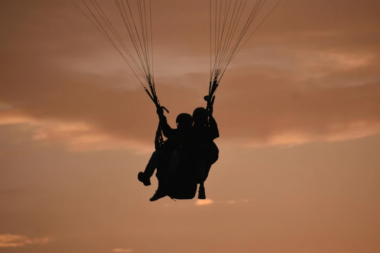 two people holding wires are climbing up to the sky