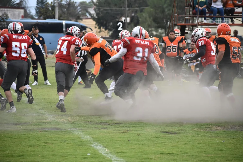 football players run for the field in unison