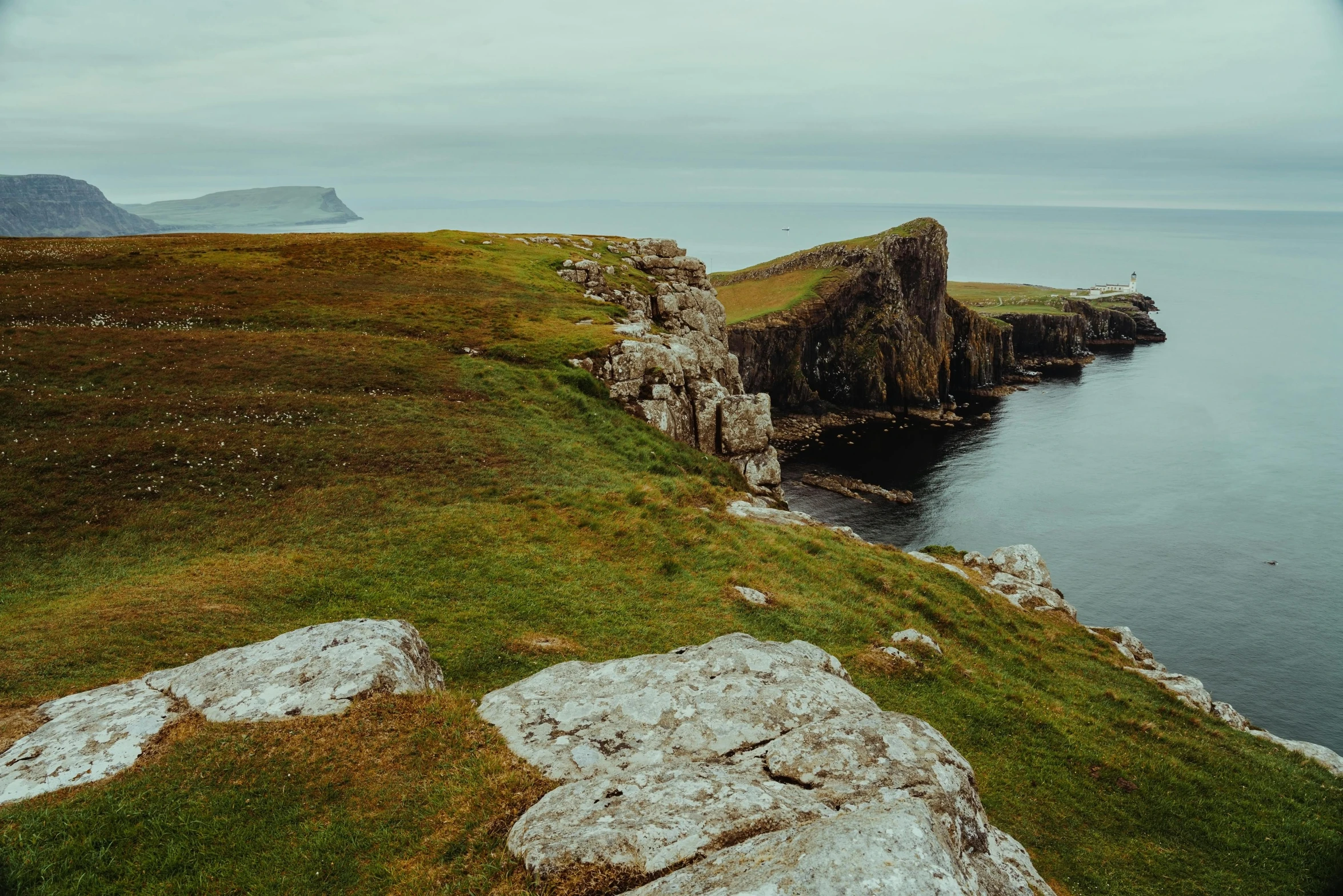 a view of a body of water with rocks near by