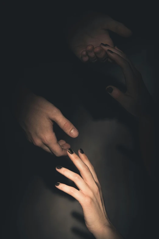 a close up of two hands and a light