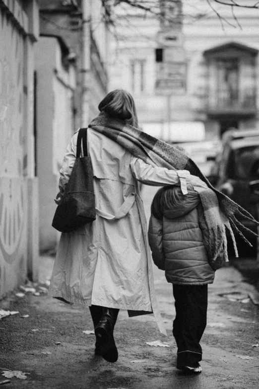 a man and woman walking down a sidewalk