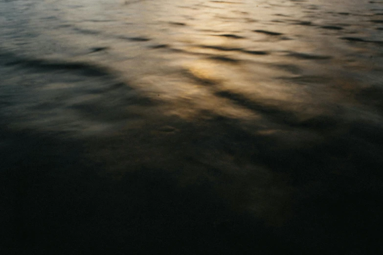 the reflection of the setting sun over water