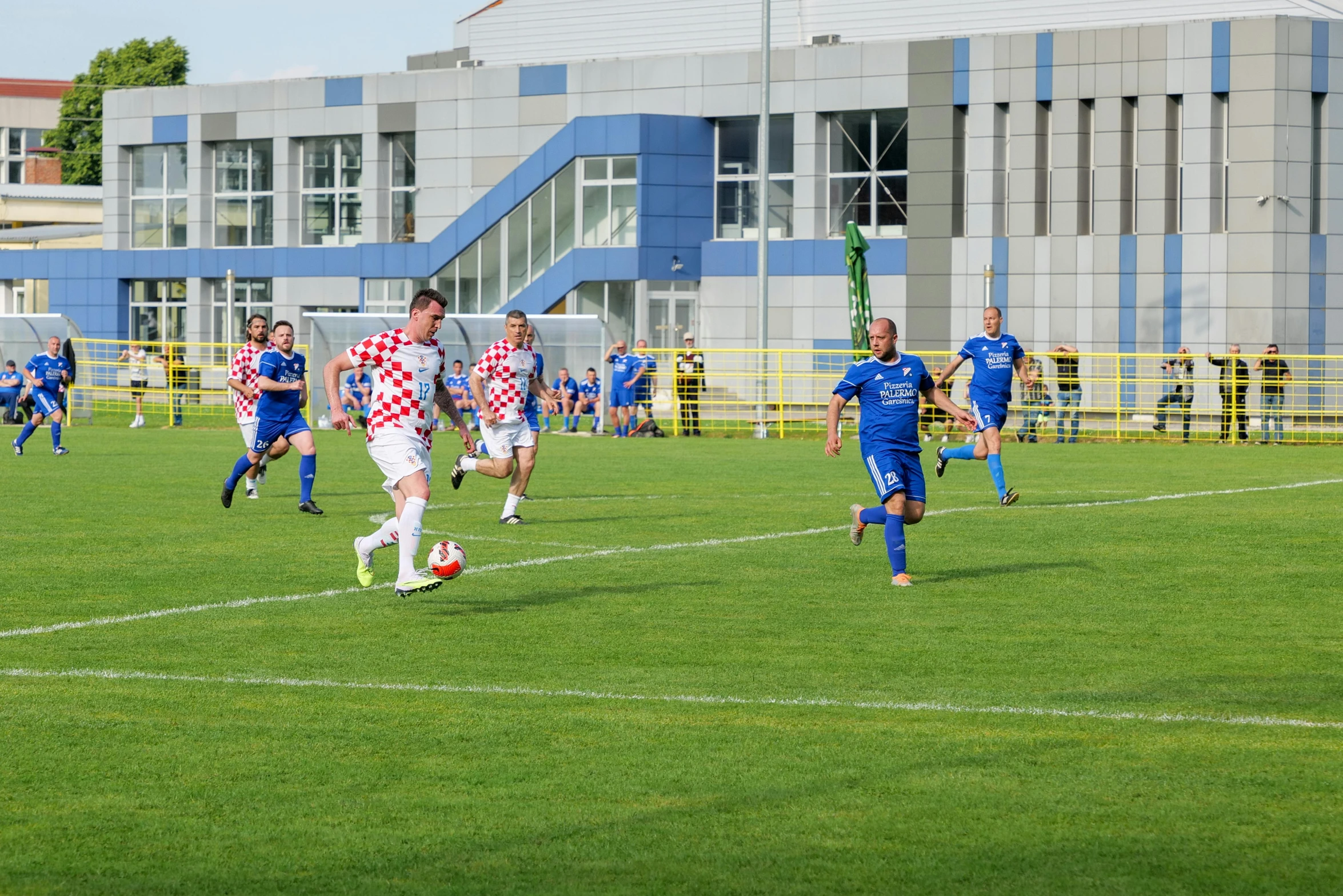 several people in action during a game of soccer