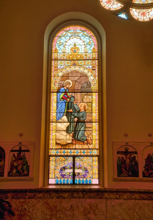 a beautiful stained glass window in the front of a church