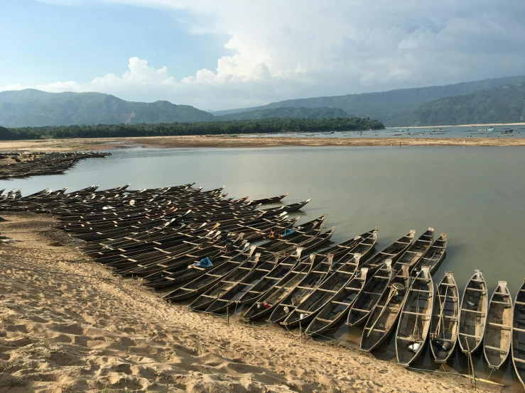 a row of boats parked on the shore