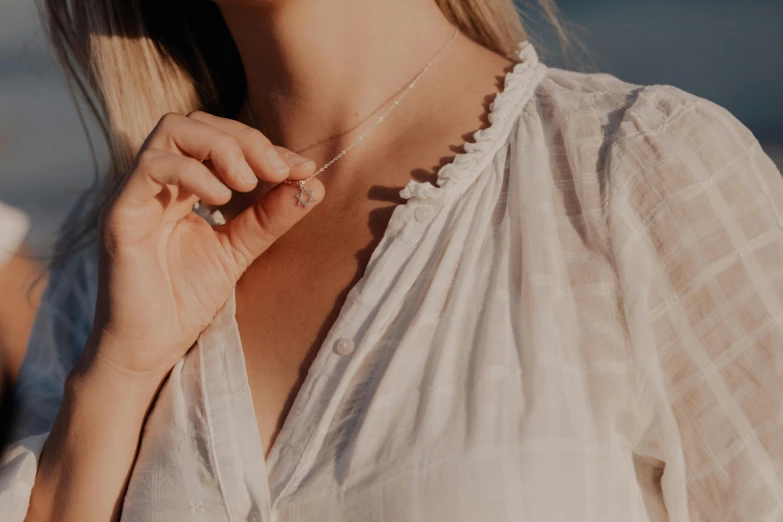 the girl is looking at the sky while she has her hands together