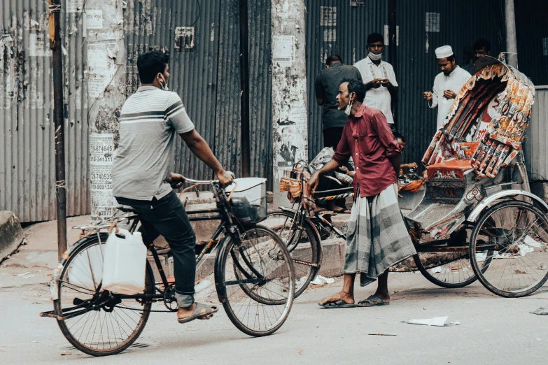 three people hing a bike with two men