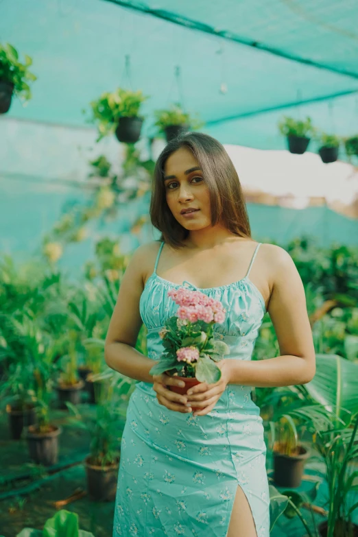 woman in blue dress holding bouquet of flowers