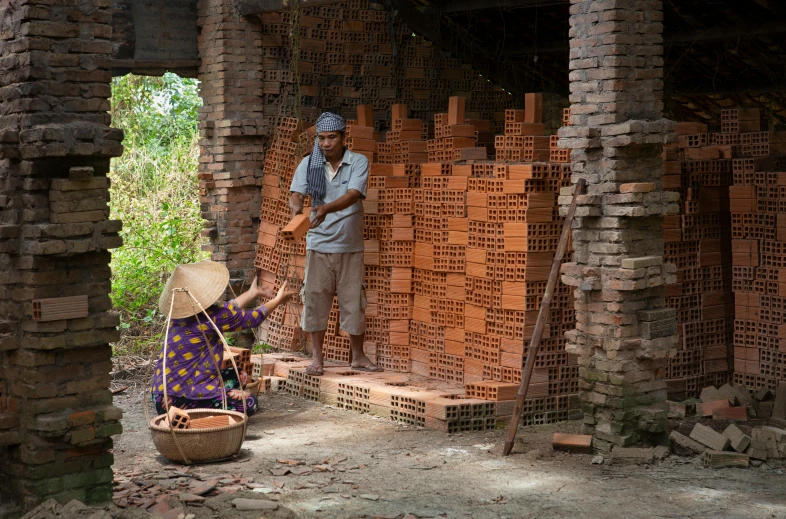 two men working together in a building made out of brick