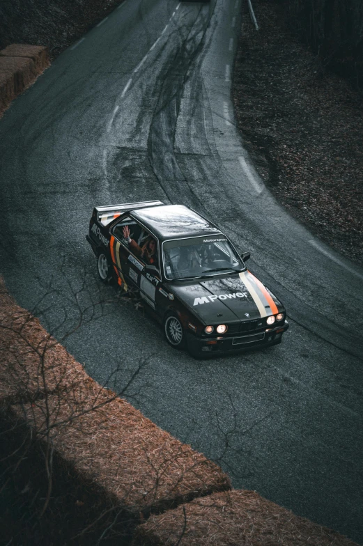 a car drives around a curve in the snow