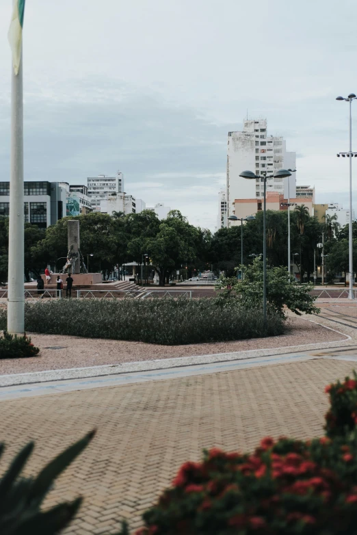 a bench with people standing on top in a city park