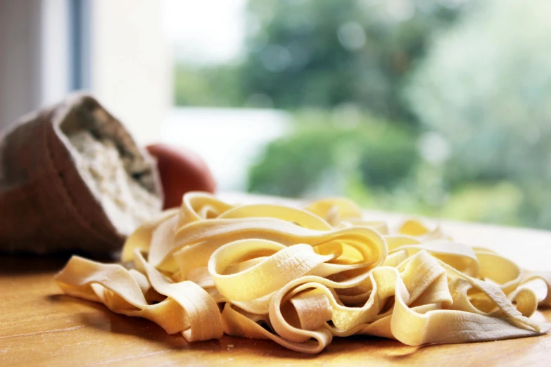 a bunch of noodles is on the floor with a person holding it