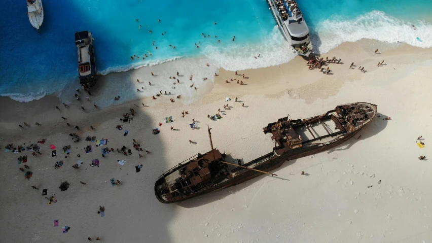 two ships on the beach in front of the ocean