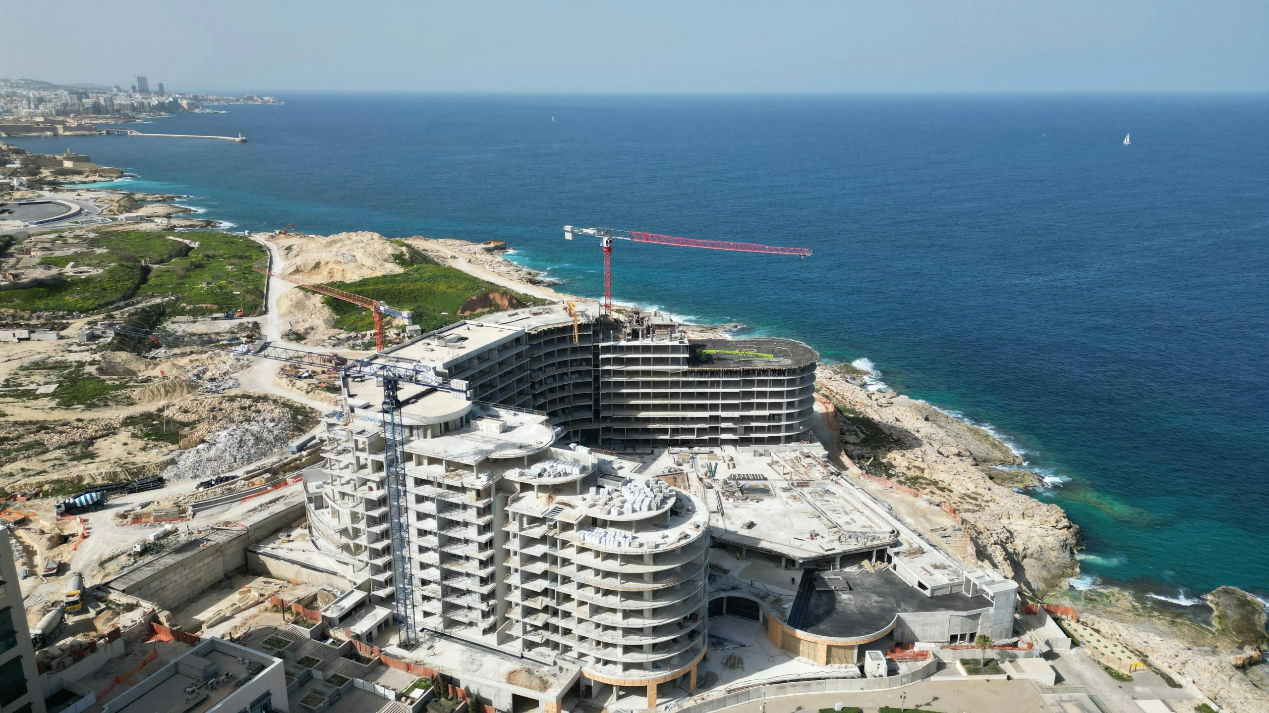 a very tall building on the shore of the ocean