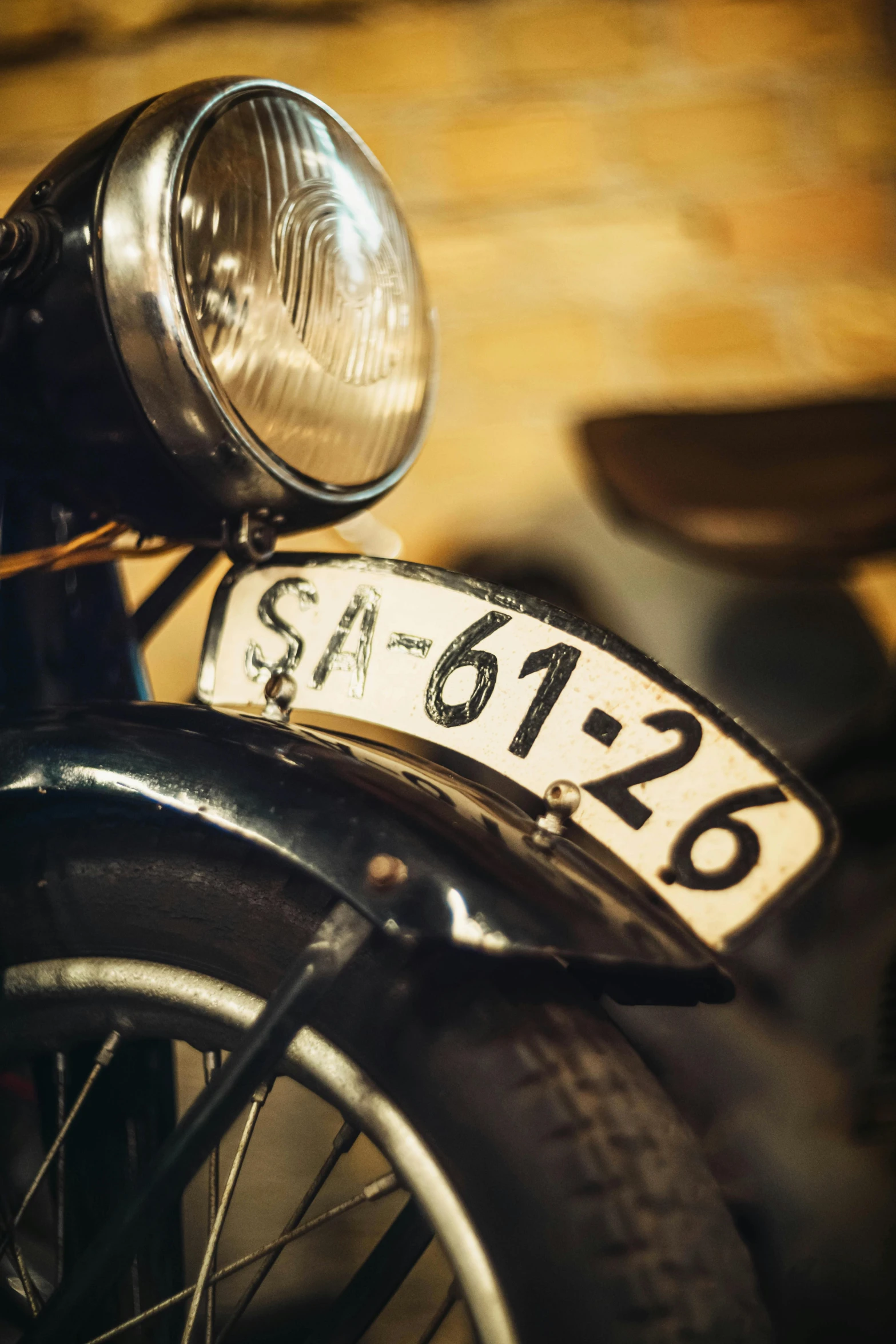 an old style motorcycle has a vintage license plate